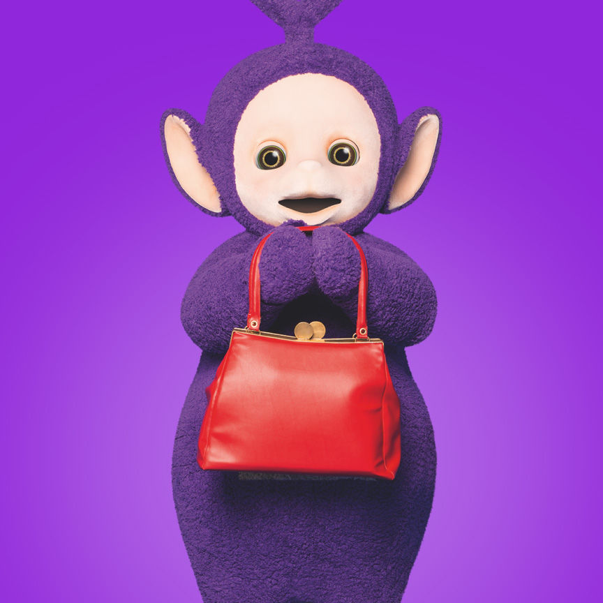 The purple Teletubby with a triangular antenna holding a red bag