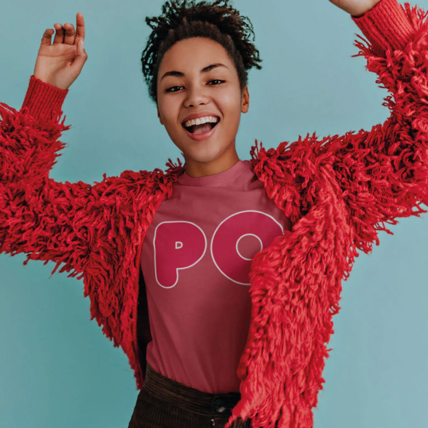 A model wearing a pink-red t-shirt with the word "po" and fluffy red jacket 