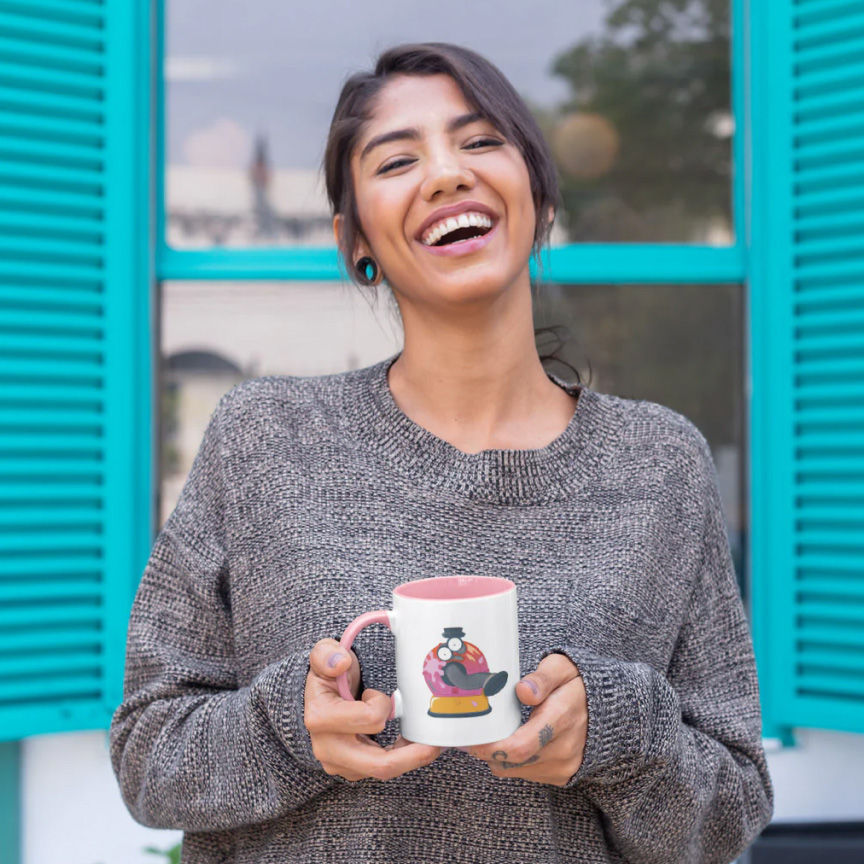 model wearing a baggy grey sweater and a coffee mug with the Teletubbies character Noo-Noo