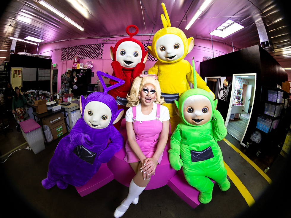 Collage of two images showing full Teletubbies x Trixie Cosmetics Collection. Left image shows Po, the red Teletubby, holding the eye shadow palette. Right image shows the blush, lashes, lip gloss, brushes, and eye shadow palette. 