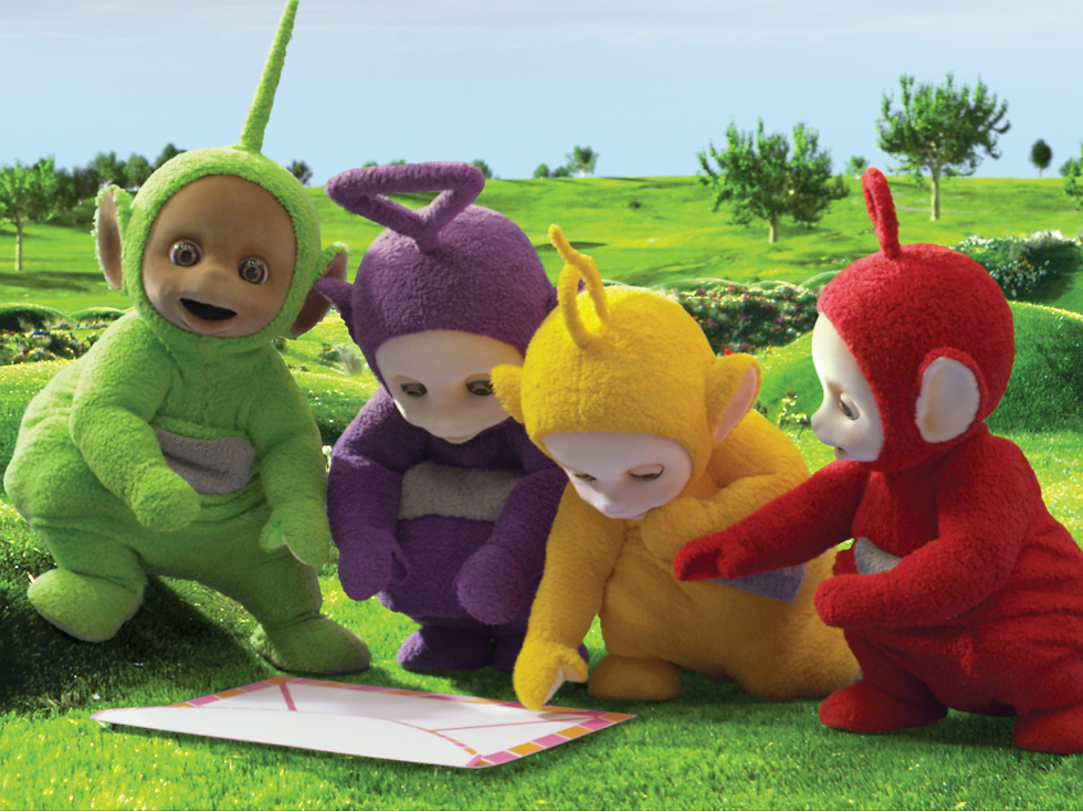 All four Teletubbies stand beside an open envelope with confetti.
