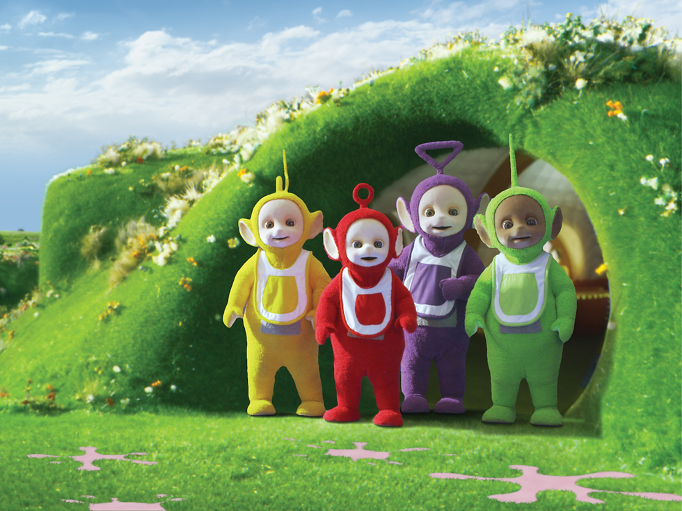 All four Teletubbies outside on the Tubby Custard Ride.