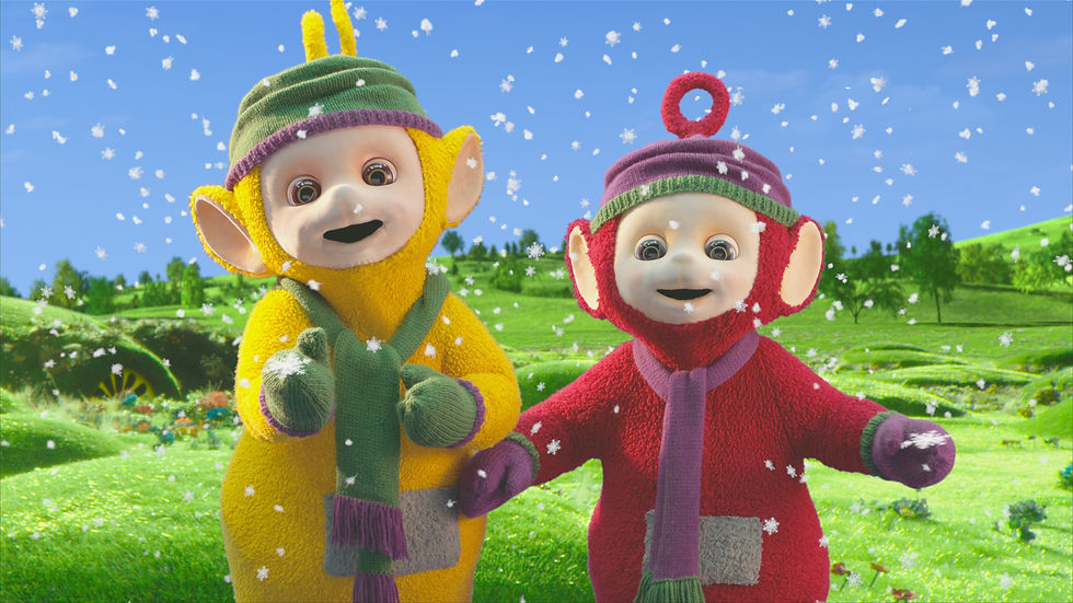 Laa-Laa and Po, the yellow and red Teletubbies, play outside in the snow.