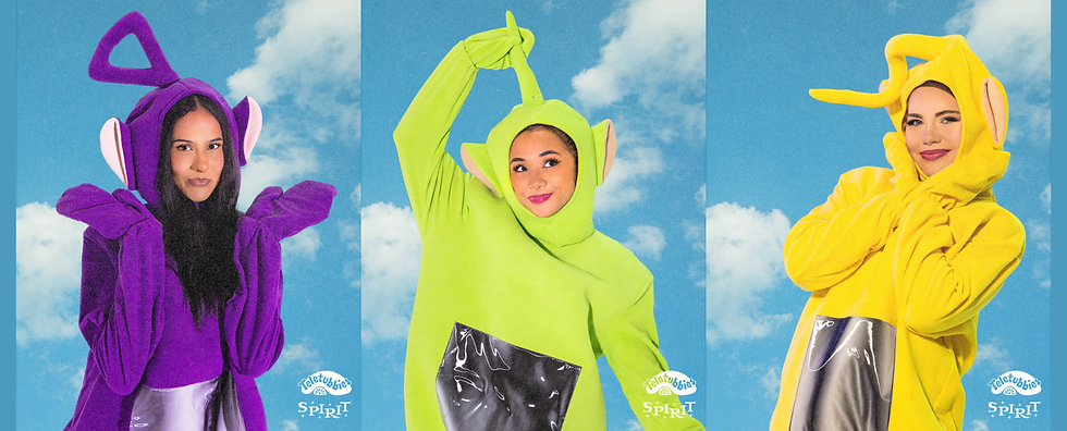 Models pose in Teletubby costumes against a blue background with white clouds.