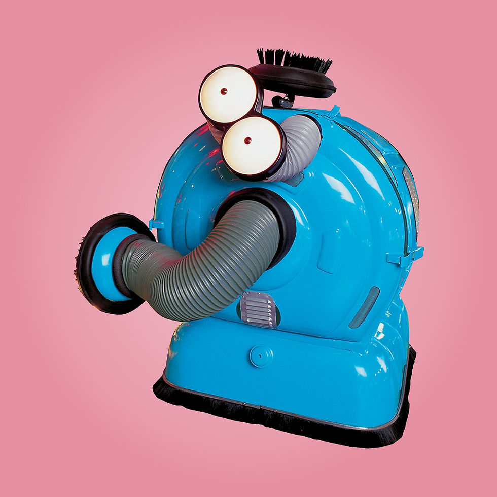 A cylinder shaped, blue character called Noo-Noo with big white eyes and long, grey nose.