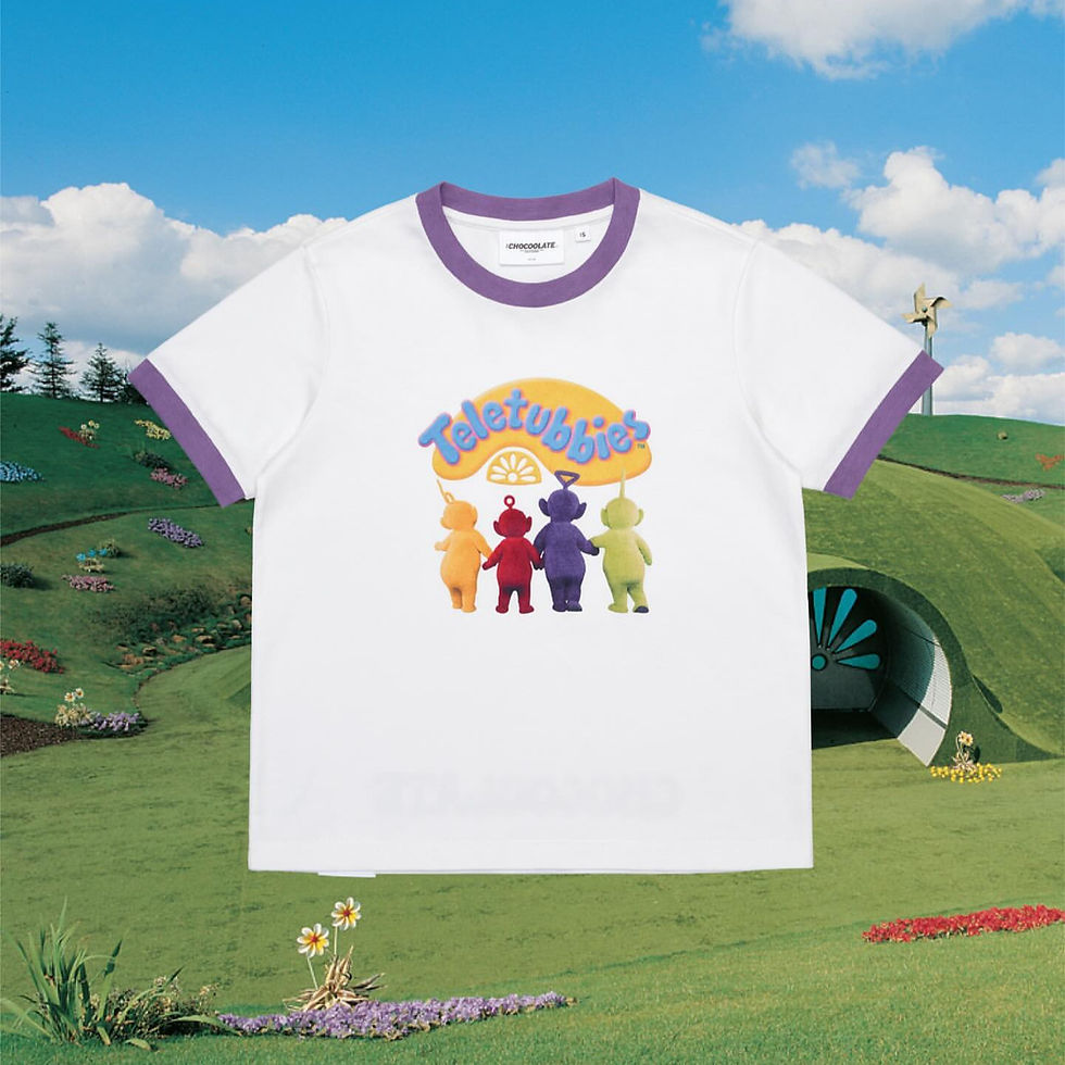White T-shirt with colourful characters with the ‘Teletubbies’ logo. The background includes green hills and a clear blue sky