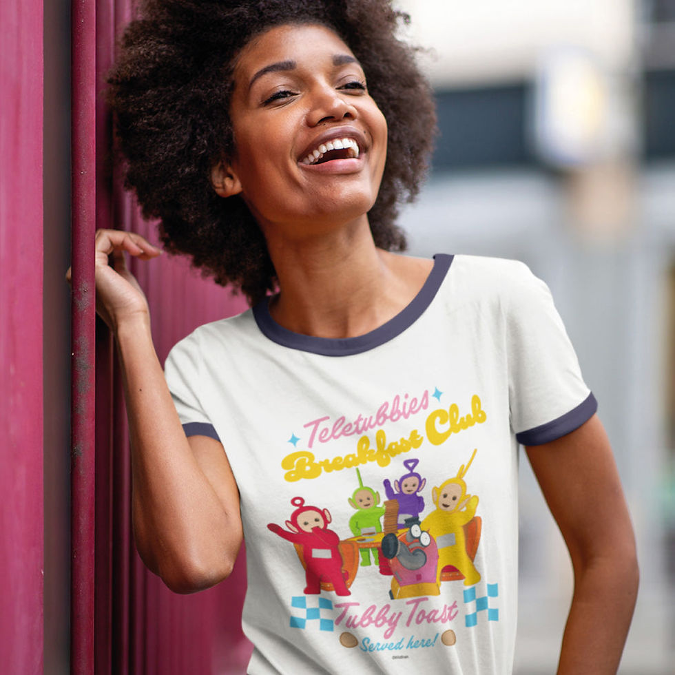 black woman with natural hair wearing a white tshirt with colourful characters on the front