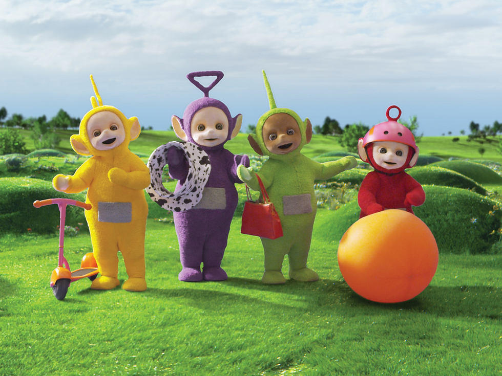 Laa-Laa, Tinky Winky, Dipsy, and Po standing on the grass with their favourite things.